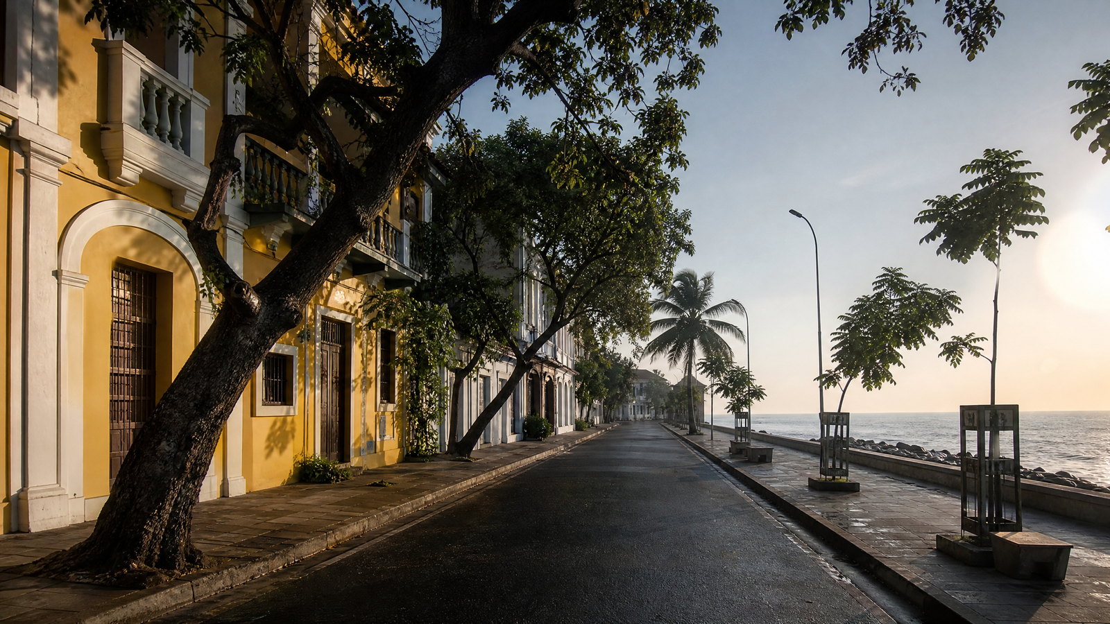 Early morning view across Puducherry’s stone-lined promenade toward pastel Franco-Tamil façades and the Bay of Bengal.