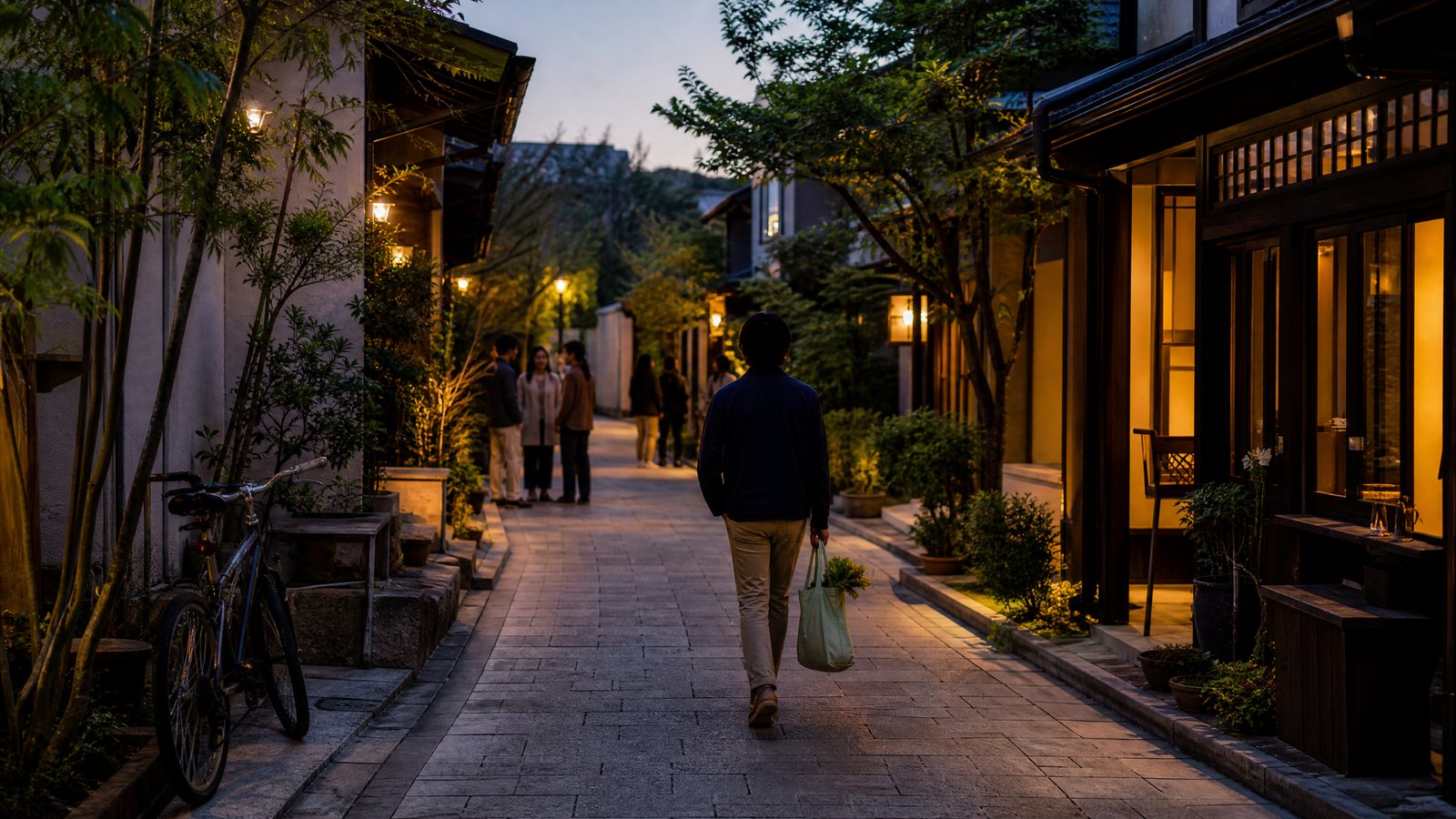 A visitor carrying a small grocery bag along a quiet residential street at dusk